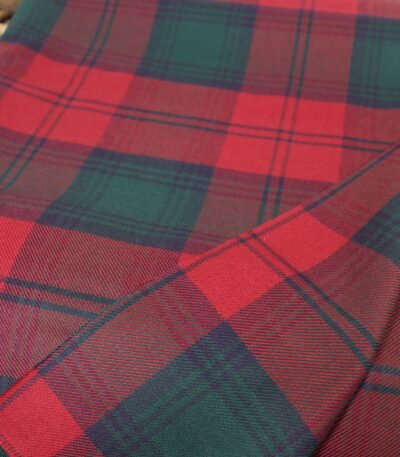 Close-up of MacGregor Tartan wool fabric showing a vibrant red base with dark green and black intersecting stripes in a twill weave.